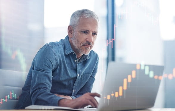 Man with beard looking at Cryptocurrency on laptop